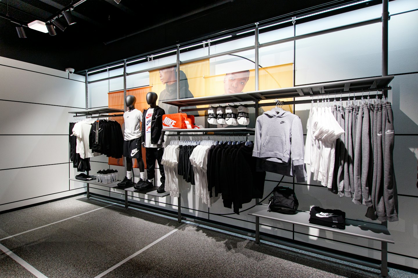 Mannequins in athletic apparel stand in a modern sportswear store.