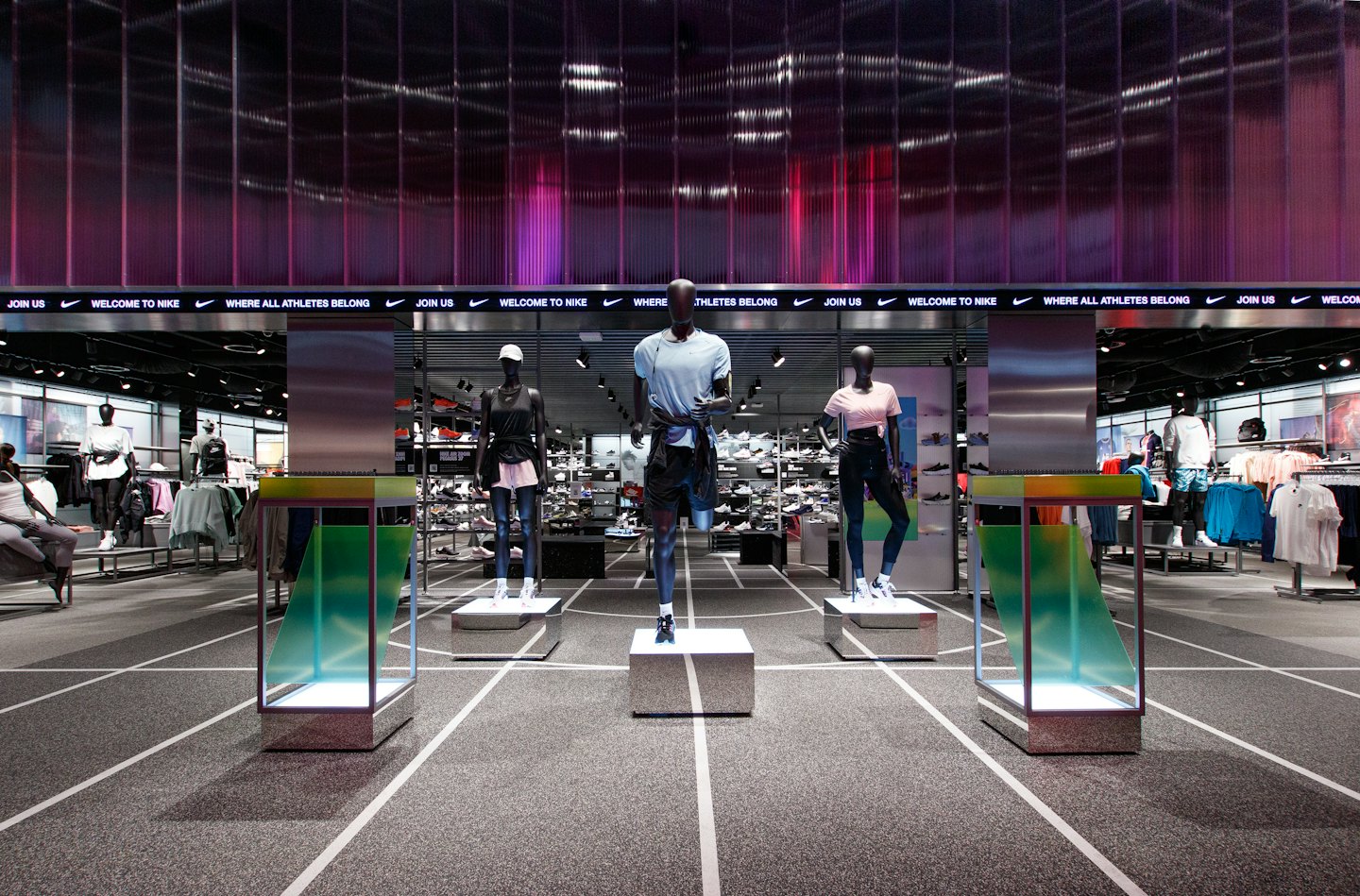 Mannequins dressed in athletic wear inside a modern retail store.
